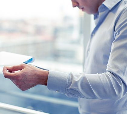 Male employee holding business papers